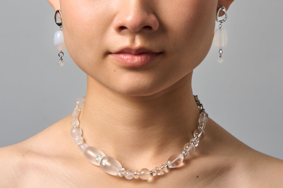 The Queen of Winter worn as a necklace at the neck, with matching drop earrings