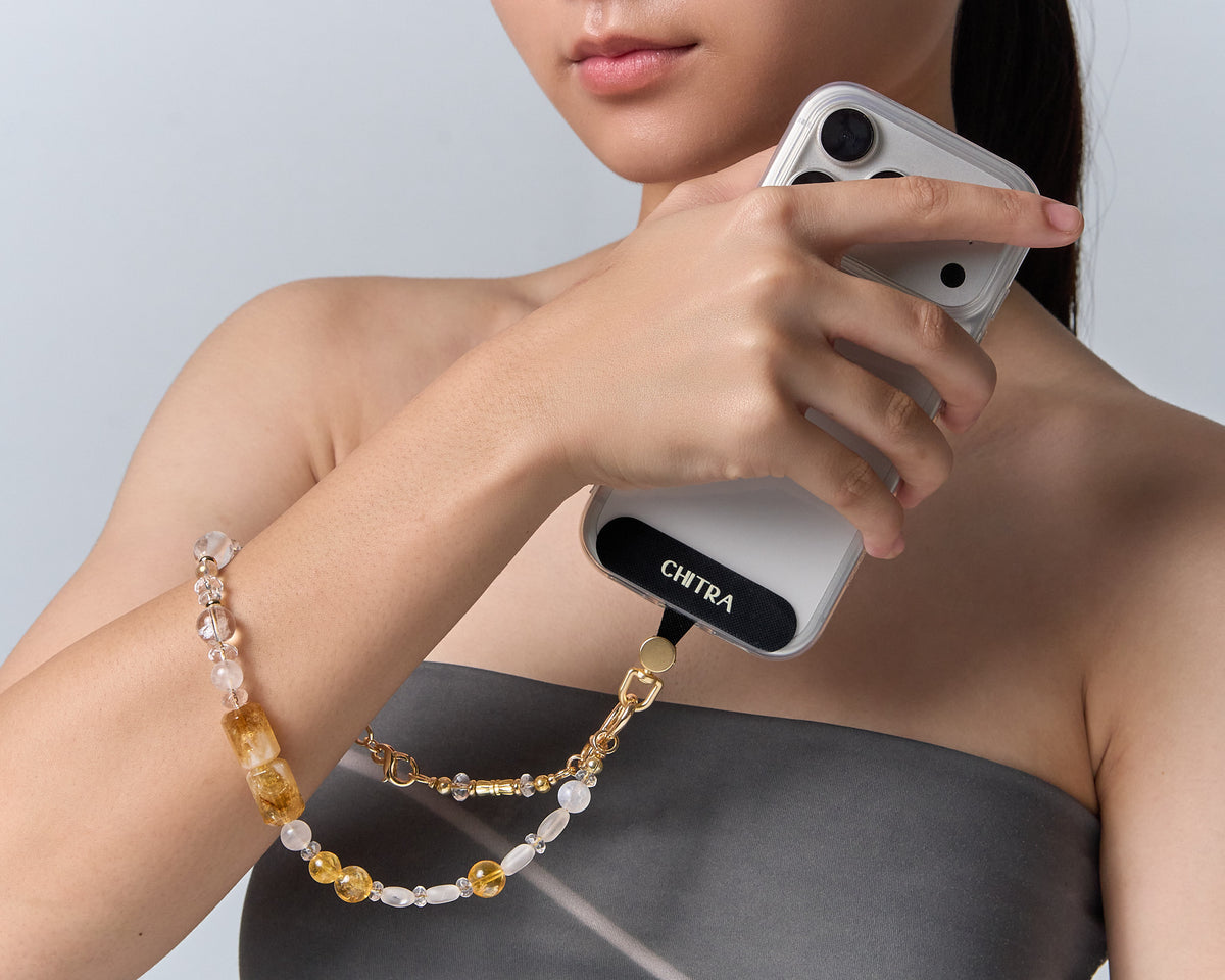 The Golden Winter clipped to a phone and held at the shoulder