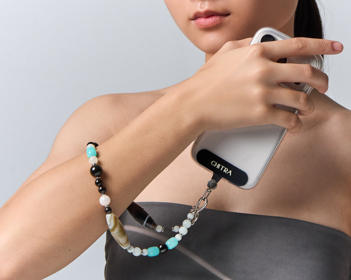 The Serenity clipped to a phone and held at the shoulder