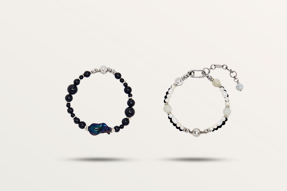 The Black Pearl split into its two bracelets, black stones and white pearls