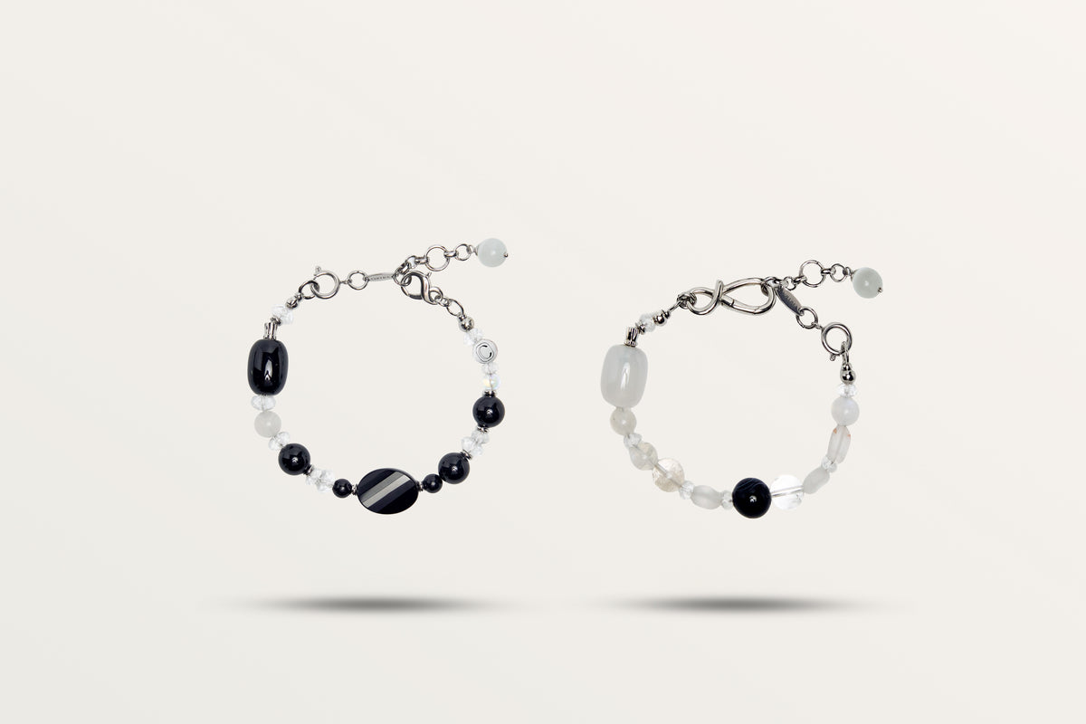 The Yin Yang split into its two bracelets, black and white stones