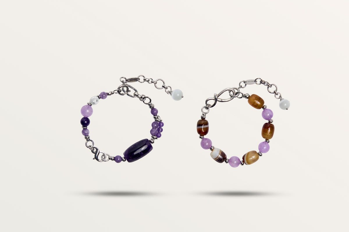 The Violet Chocolate split into its two bracelets, purple stones on one and brown banded stones on the other