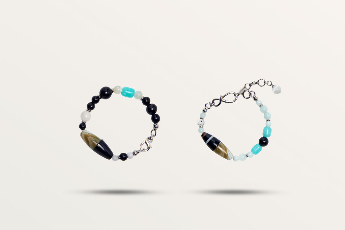 The Serenity split into its two bracelets, black and turquoise stones with a striped barrel bead