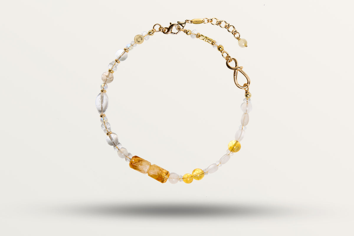 The Golden Winter as a necklace, one closed loop of honey and milky stones on gold-tone hardware