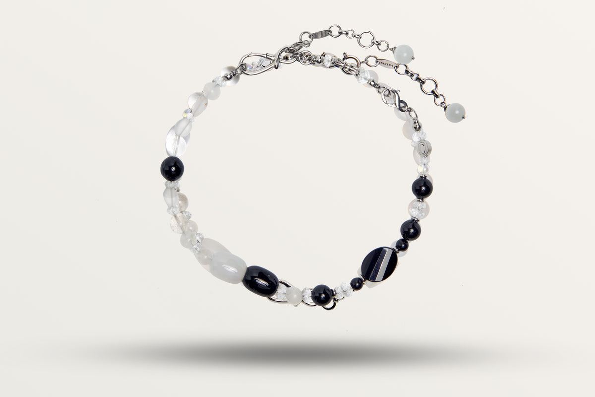 The Yin Yang as a necklace, black and white stones, closed with both connectors together and the two extender chains hanging