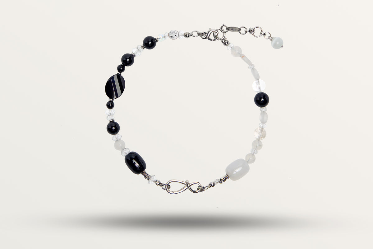 The Yin Yang as a necklace, one closed loop of black and white stones