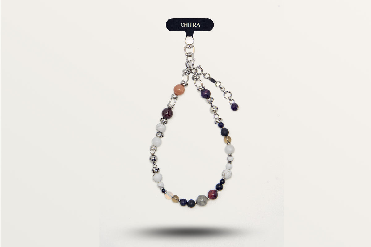 The Empower and Protect hanging as a phone charm, mixed dark and pale stones with steel spacers