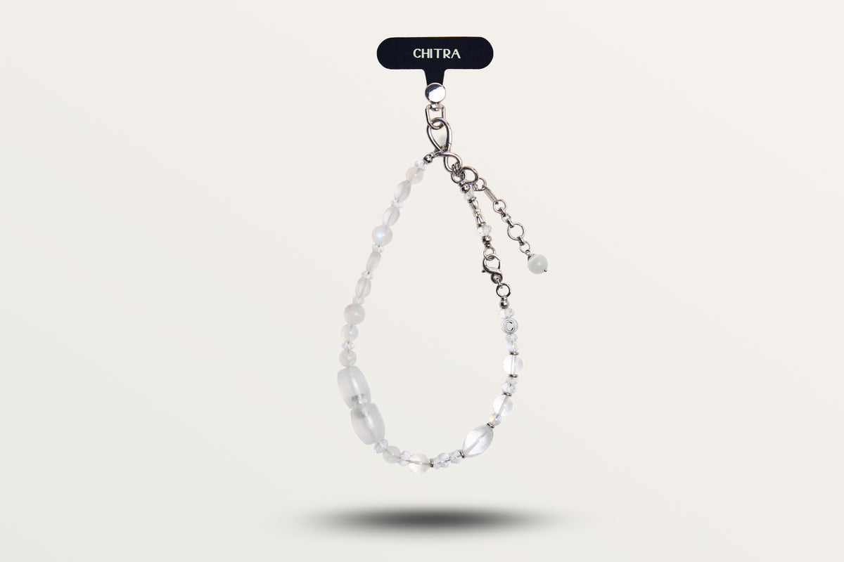 The Queen of Winter hanging as a phone charm, frosted and clear white stones
